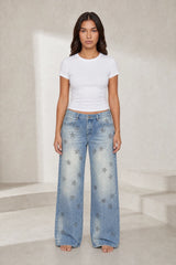 Low-rise faded blue jeans with stars